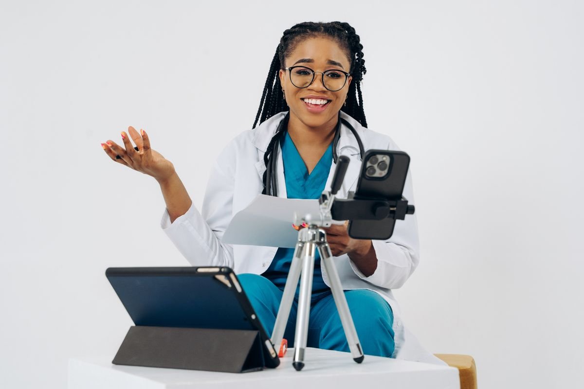 Healthcare professional using a smartphone and tablet